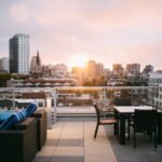 A rooftop terrace lounge area overlooking a city skyline