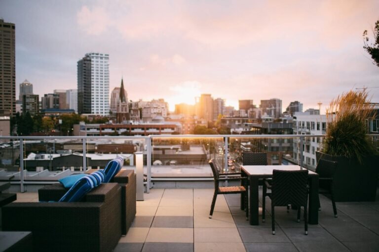 A rooftop terrace lounge area overlooking a city skyline